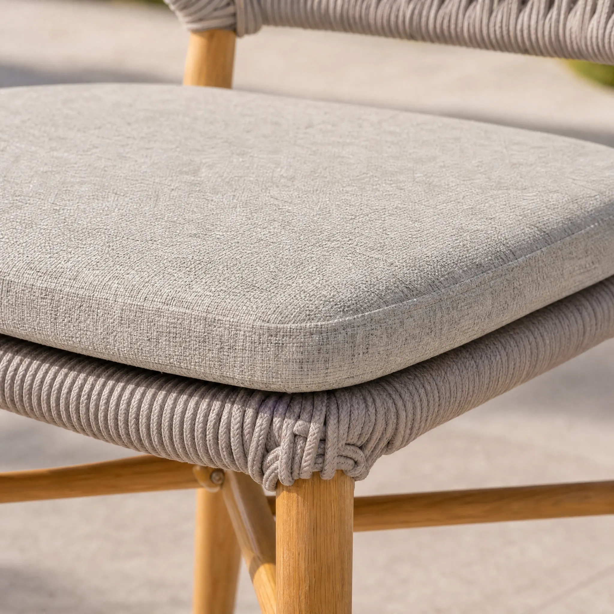 Generated with Kive.ai - Create a distinct close-up detail shot of the light gray seat cushion from Woven dining chair. Use Image 1 as the visual reference for the cushionâs exact shape_ fabric color_ fine wea.png